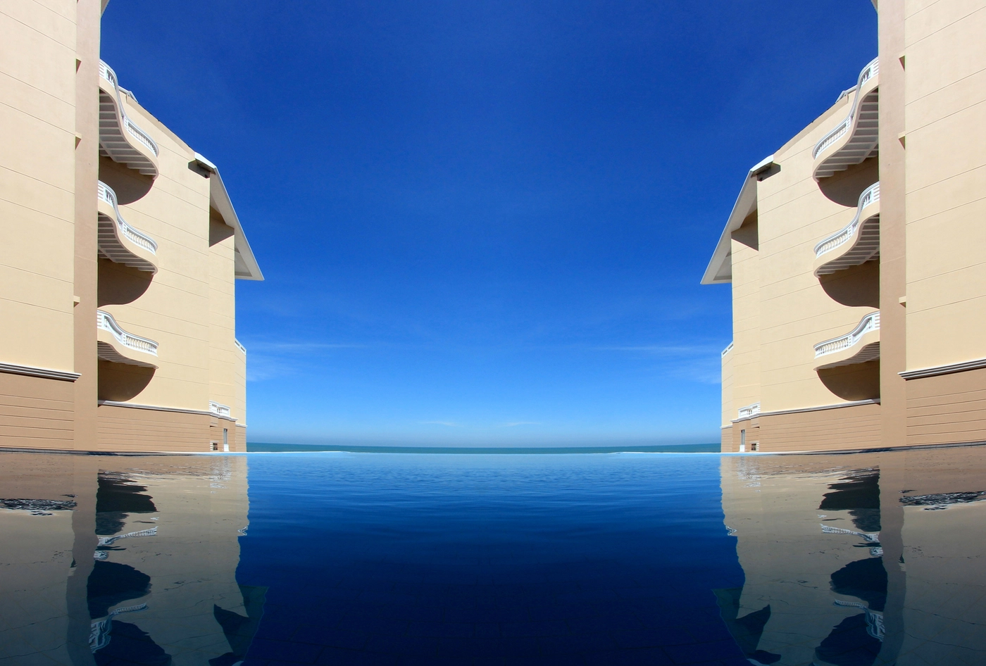 Infinity pool framed by Sea Pearl resort wings