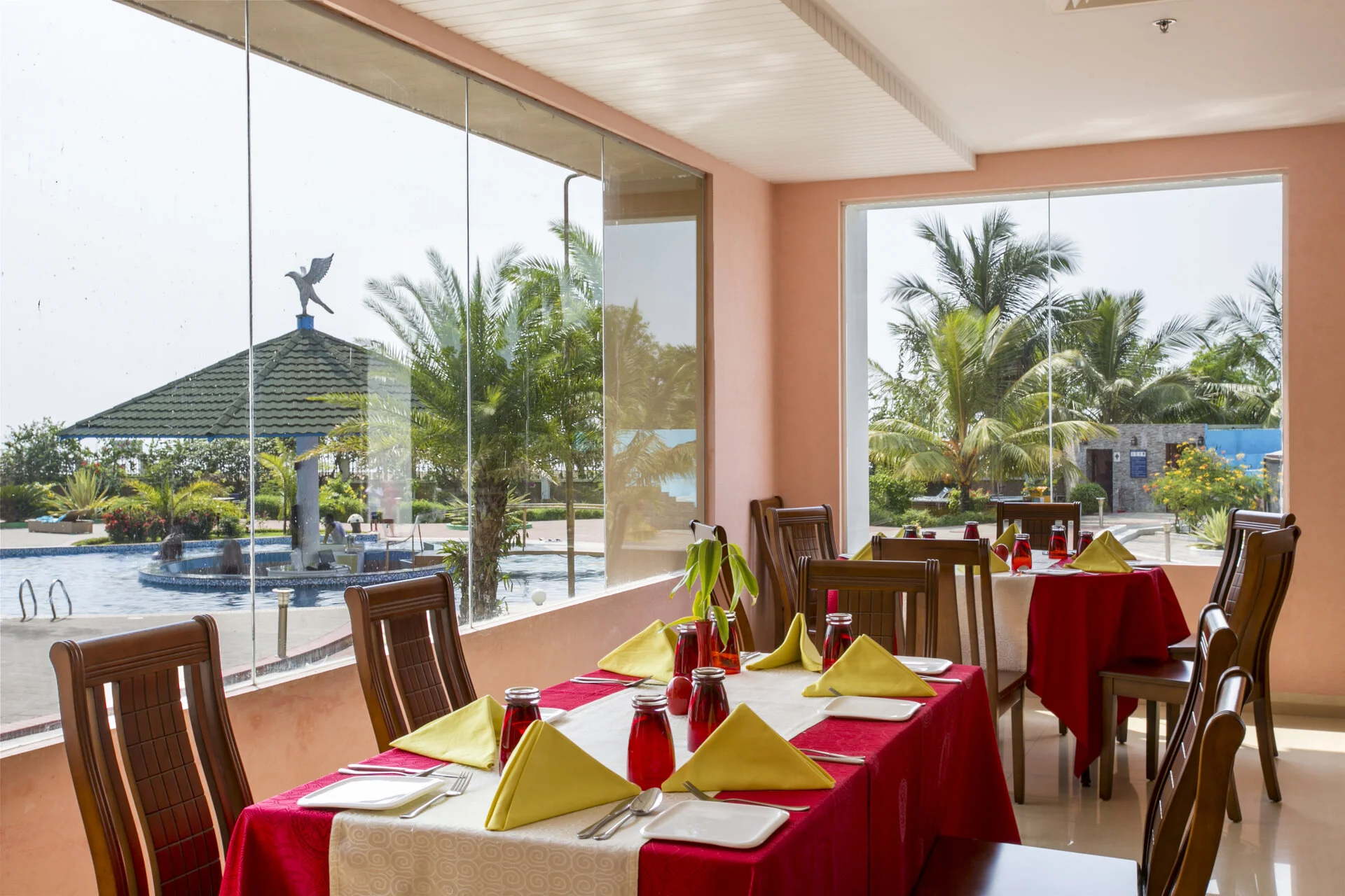 Beachfront dining area overlooking the pool and gardens