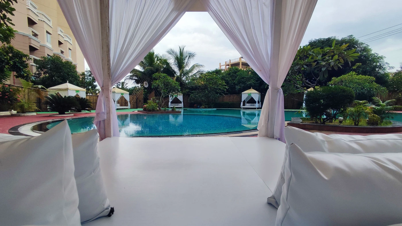 Private white-draped cabana beside the spa pool
