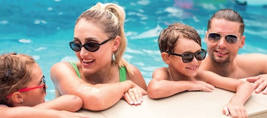 Family enjoying time together in a swimming pool